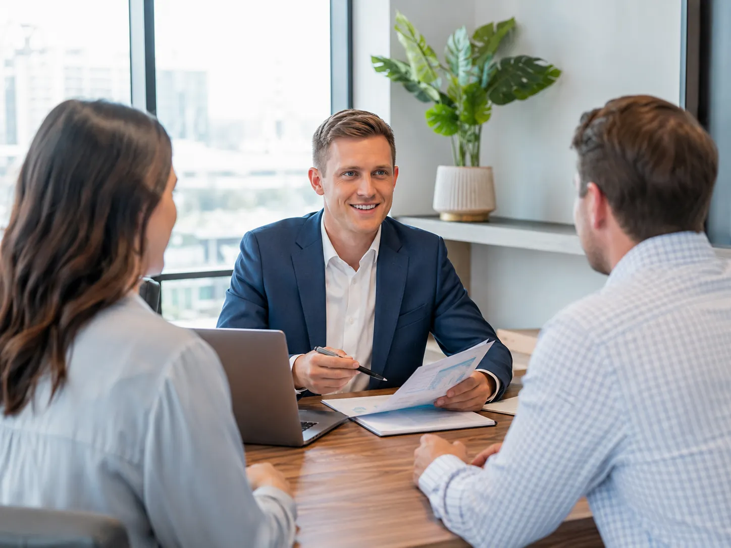Cooper Norman business tax advisor consulting with clients in an office.