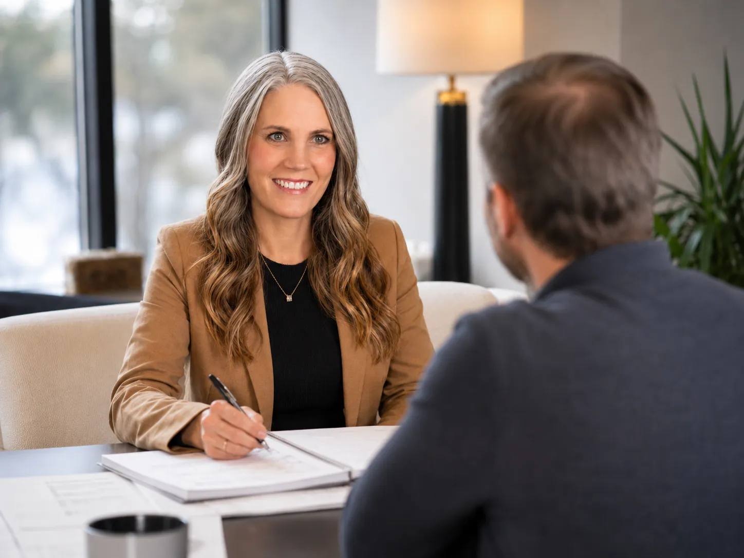 Cooper Norman advisor leading a client consultation in an office.