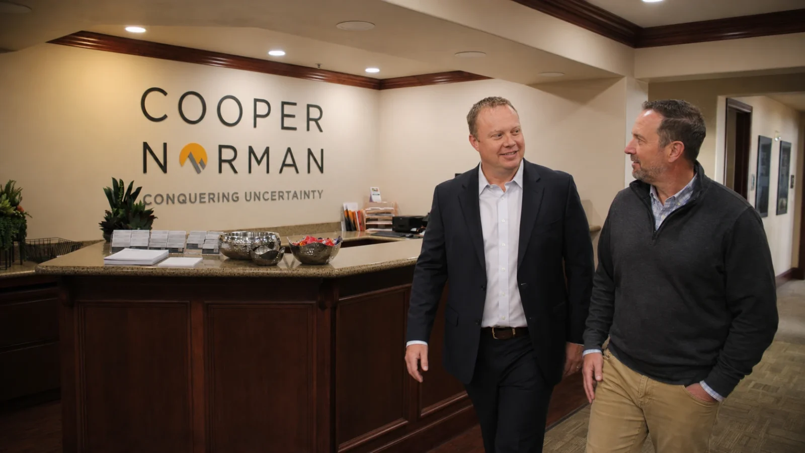 Cooper Norman team members walk through the firm's front lobby.