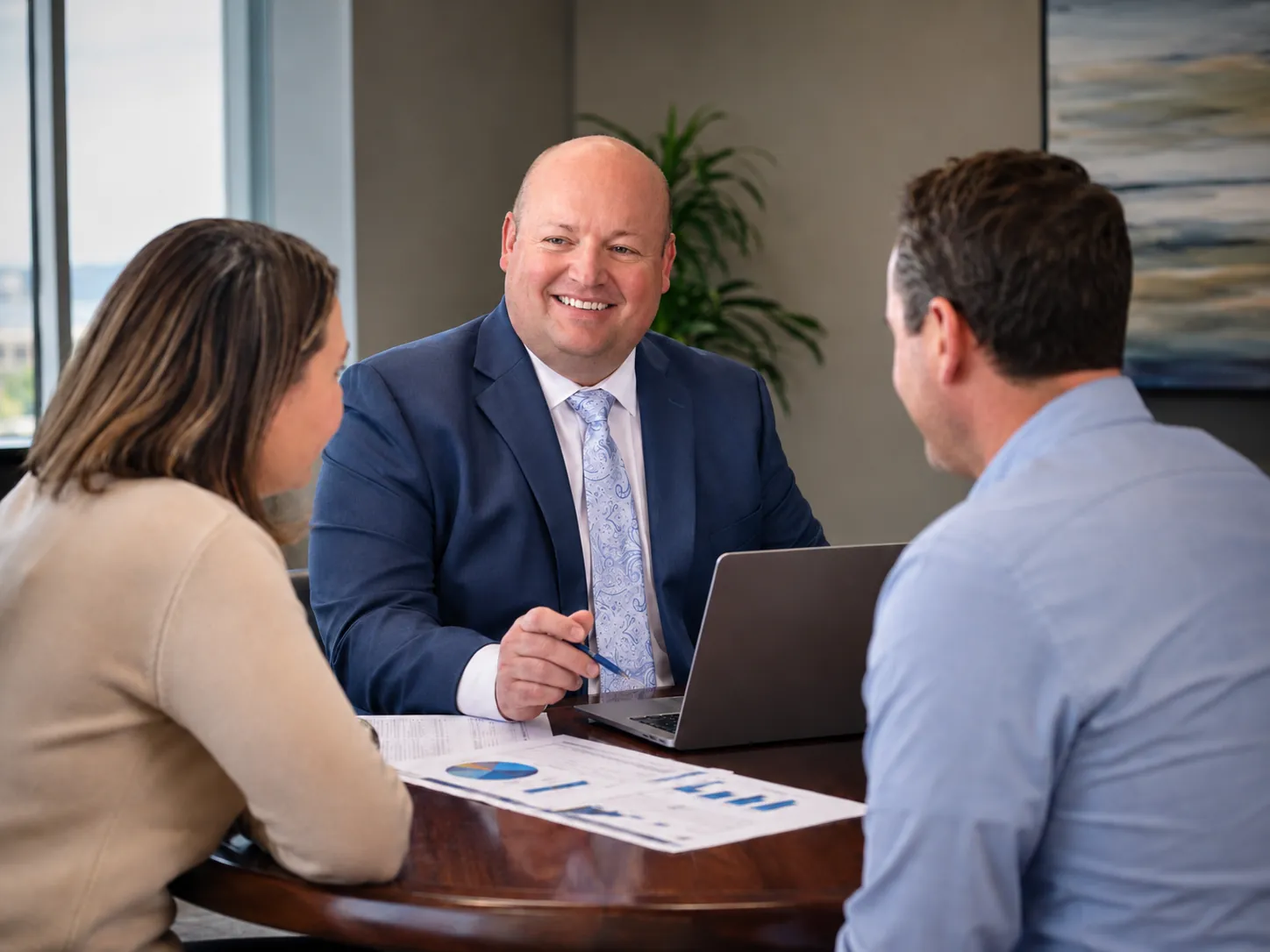 Cooper Norman senior CPA reviewing financial documents with clients.